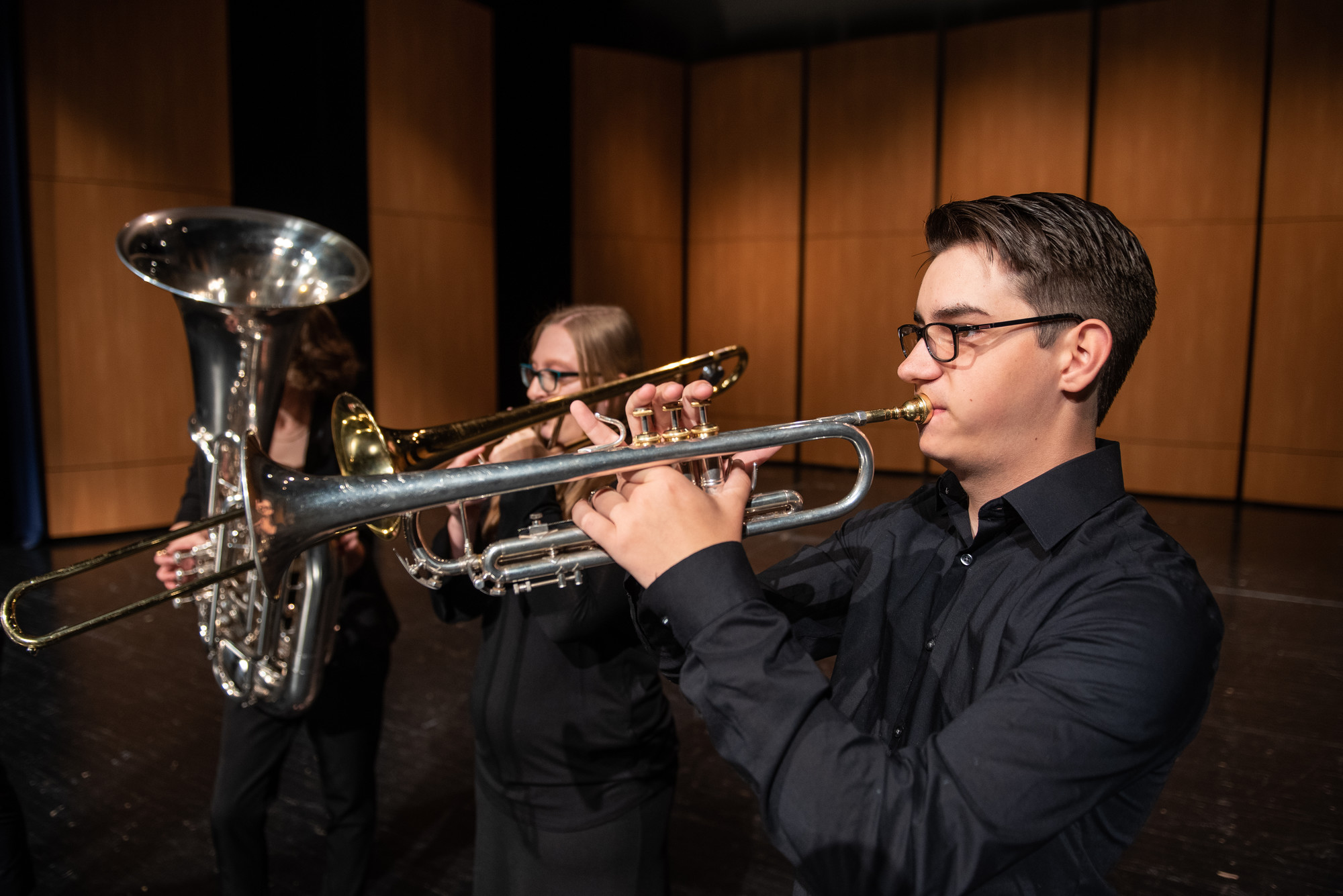 Students performing on brass instruments in Malcolm Field Theatre